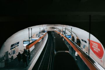 A busy Paris metro station captured with commuters waiting for their train.
